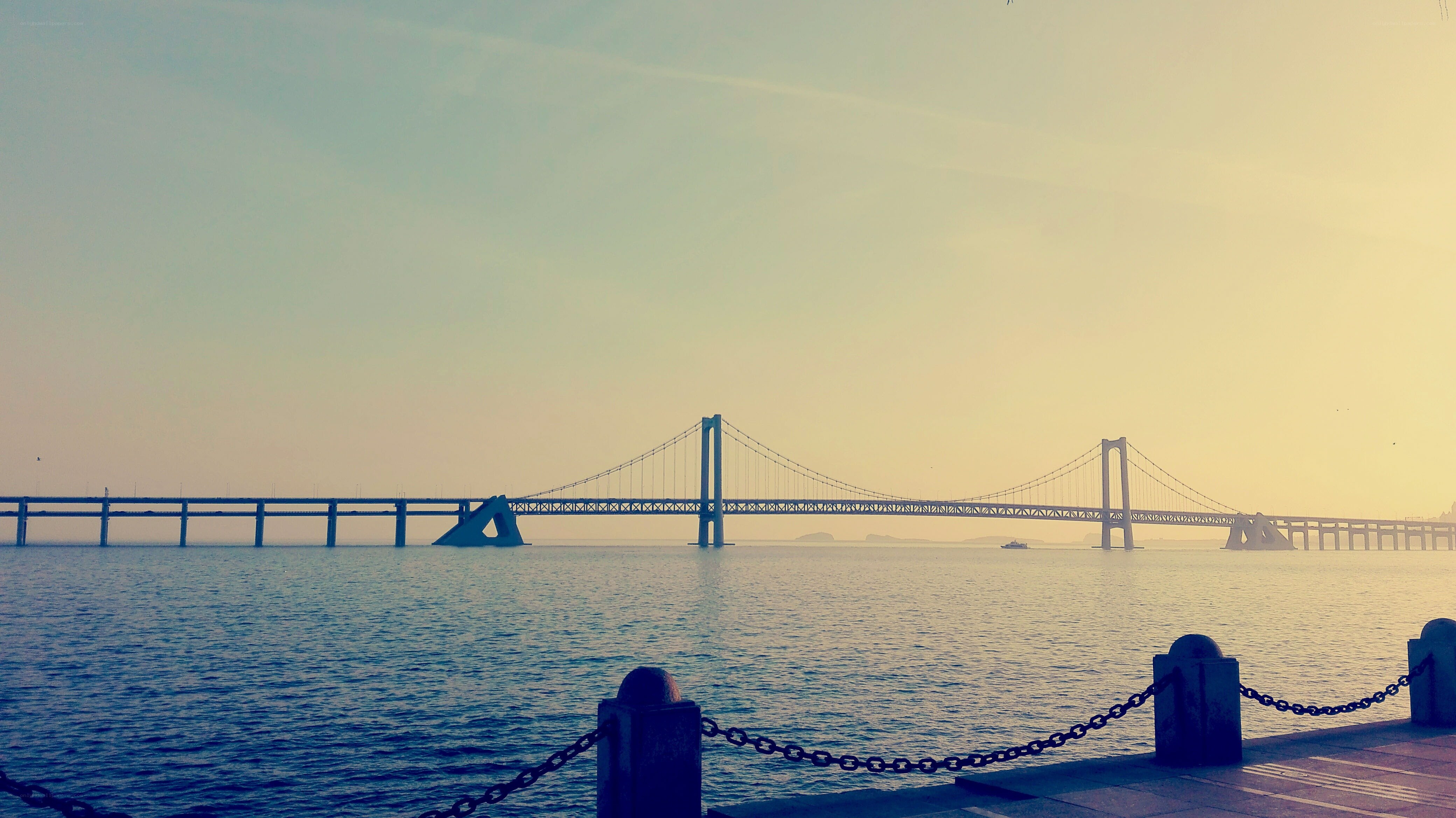Bridge over calm water at sunset