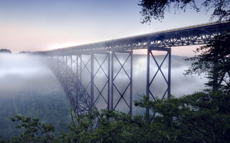 Bridge over foggy valley