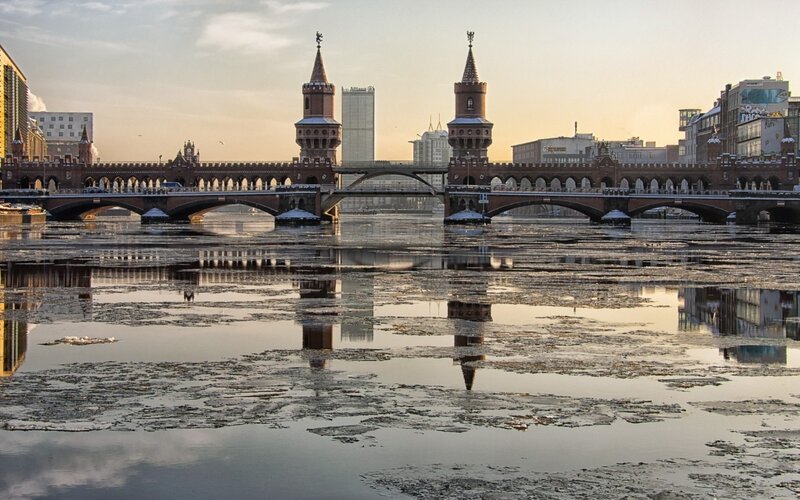 Bridge over icy river at sunset