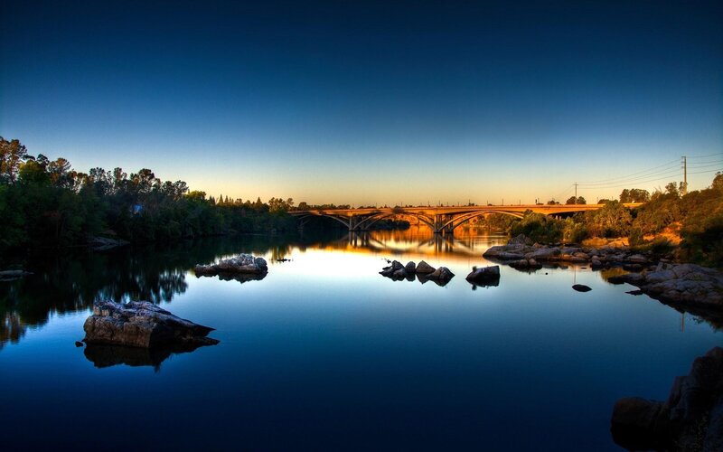 Bridge over River at Dusk — Blue, Serene, Sunset, Photograph, Trees