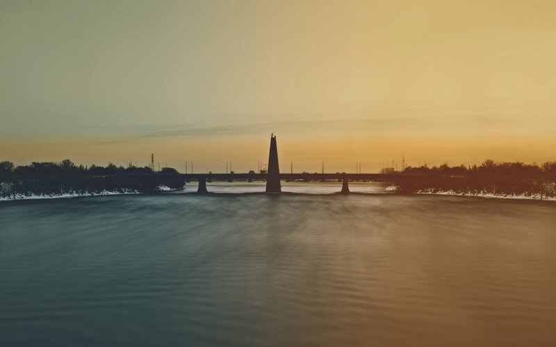 Bridge over River at Dusk — Orange, Serene