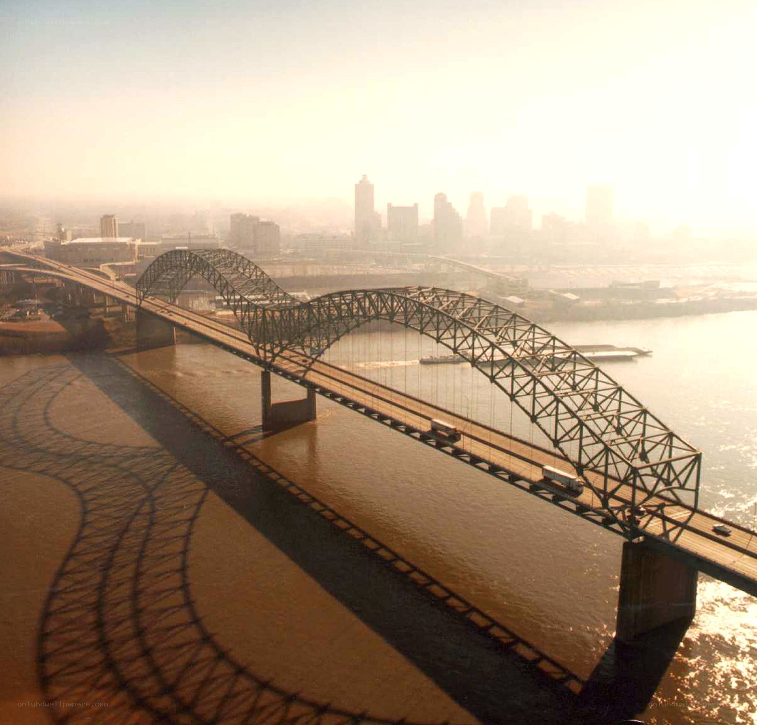 Bridge over river at sunrise