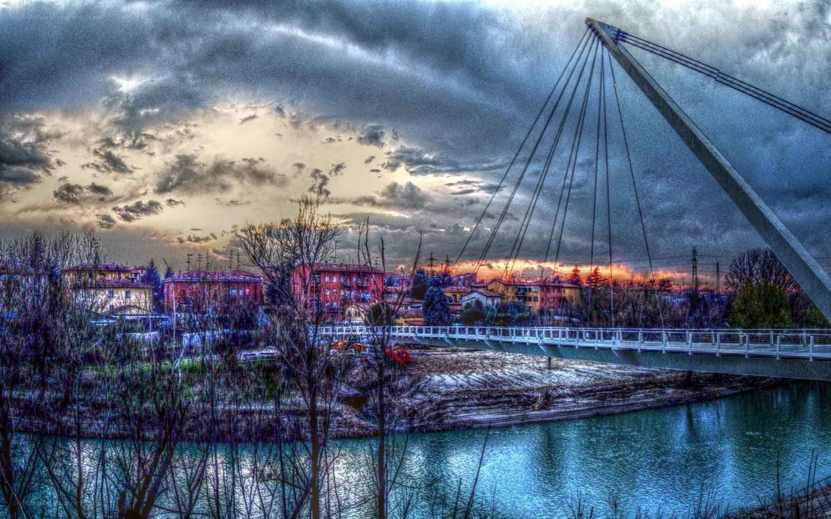 Bridge over river at sunset