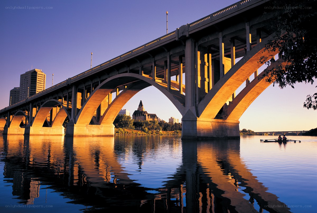 Bridge over river at sunset