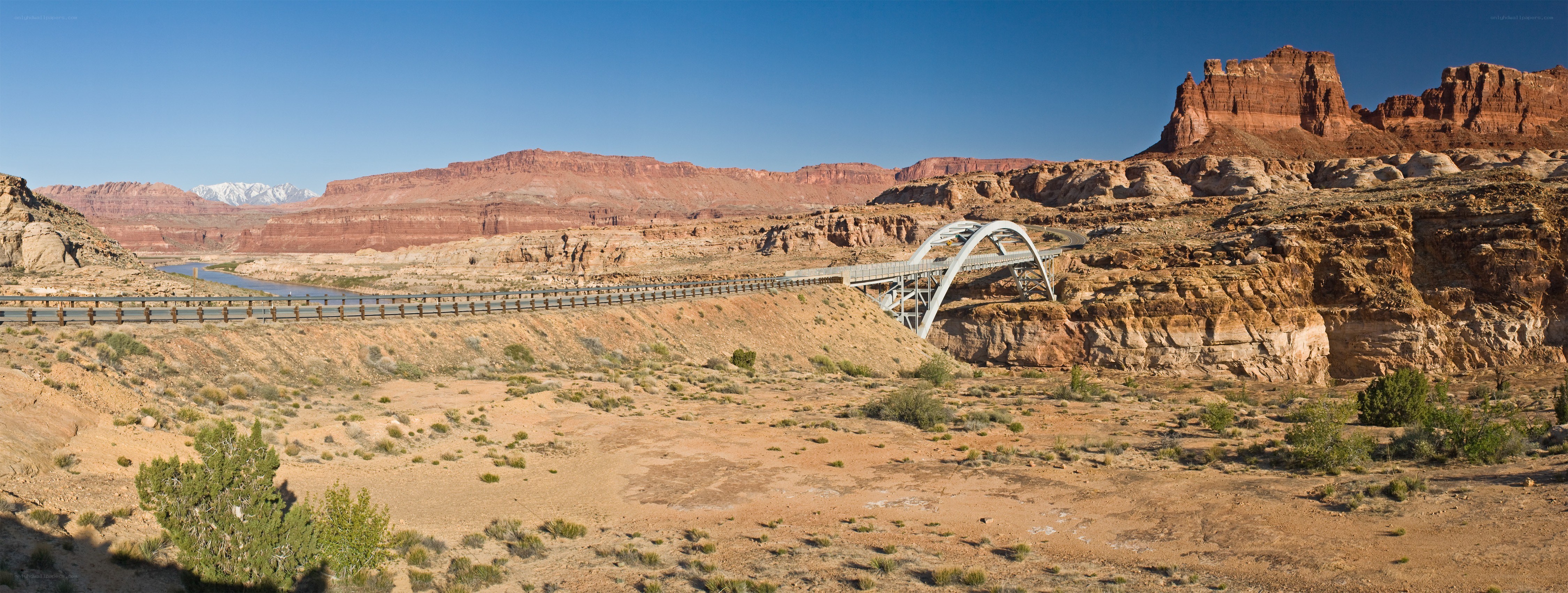 Bridge over river in desert canyon