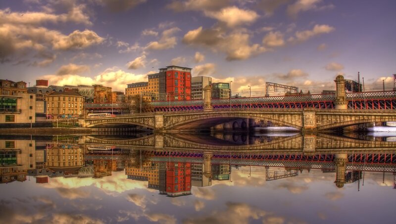 Bridge over River with Buildings — Blue
