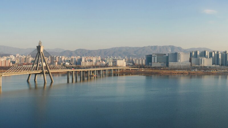 Bridge over river with city skyline