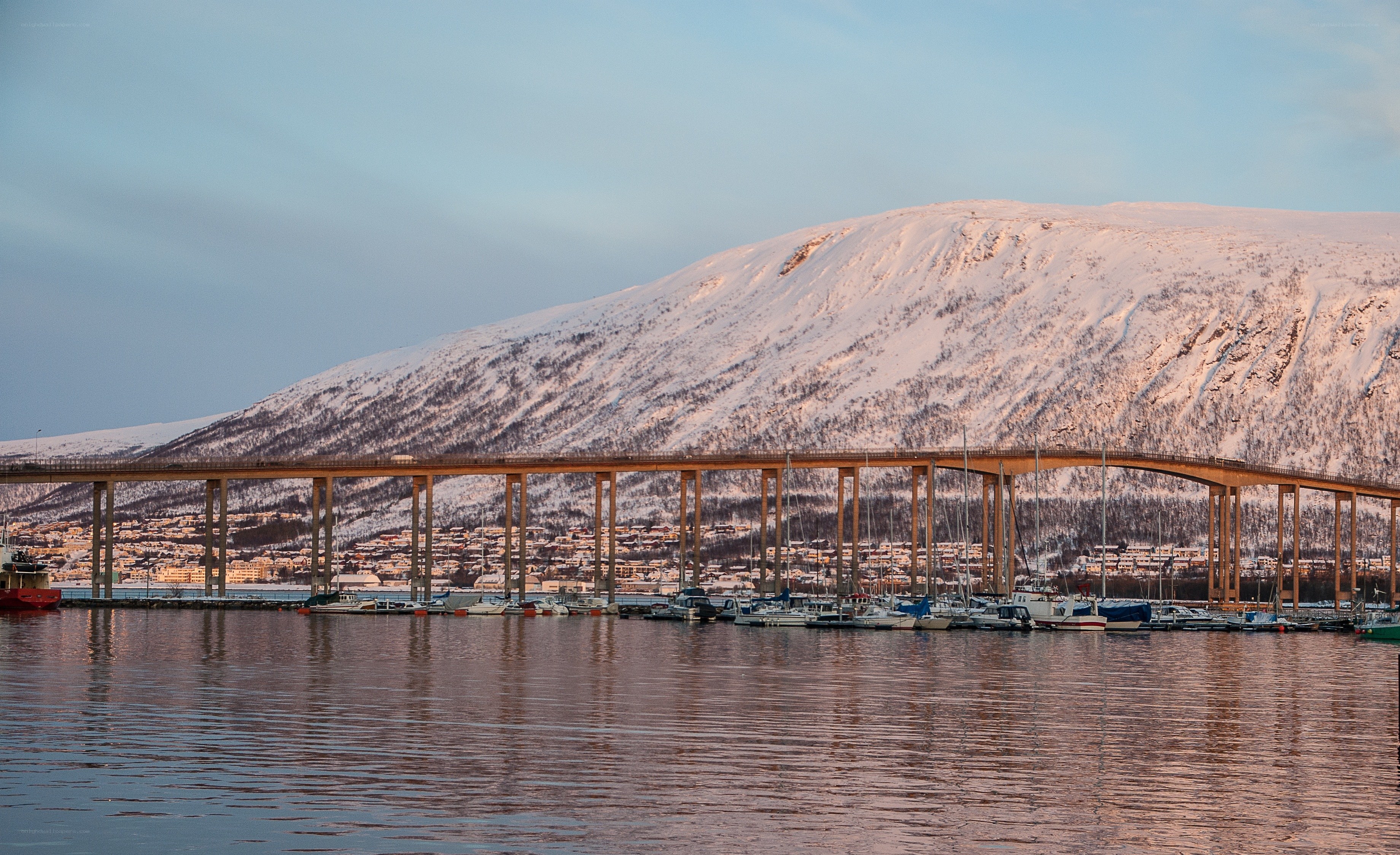 Bridge over snowy mountain harbor