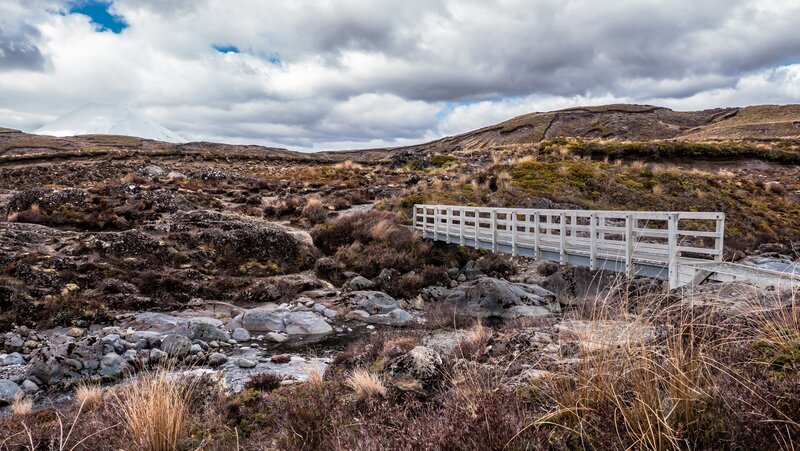 Bridge over stream in volcanic landscape