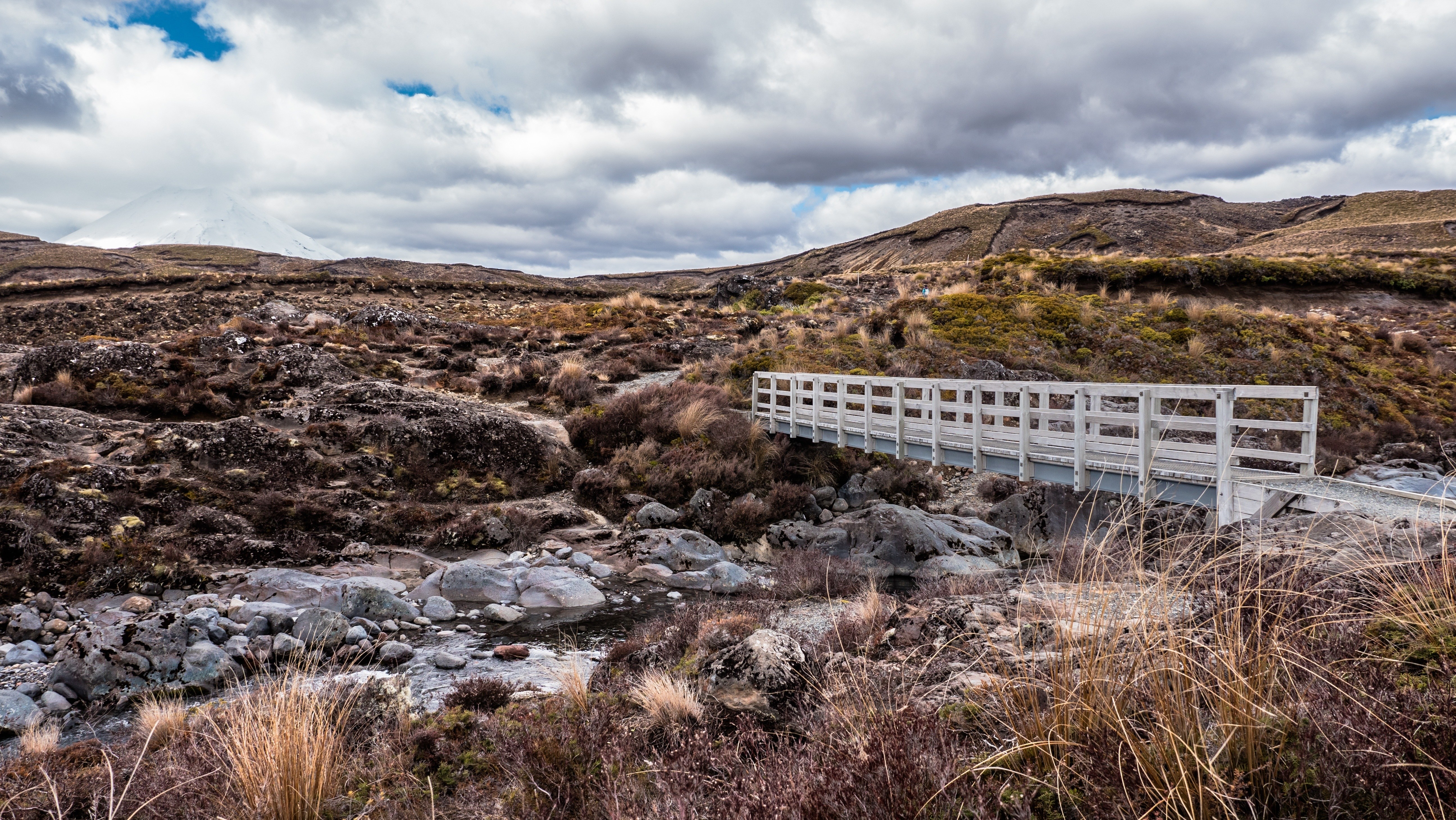Bridge over stream in volcanic landscape