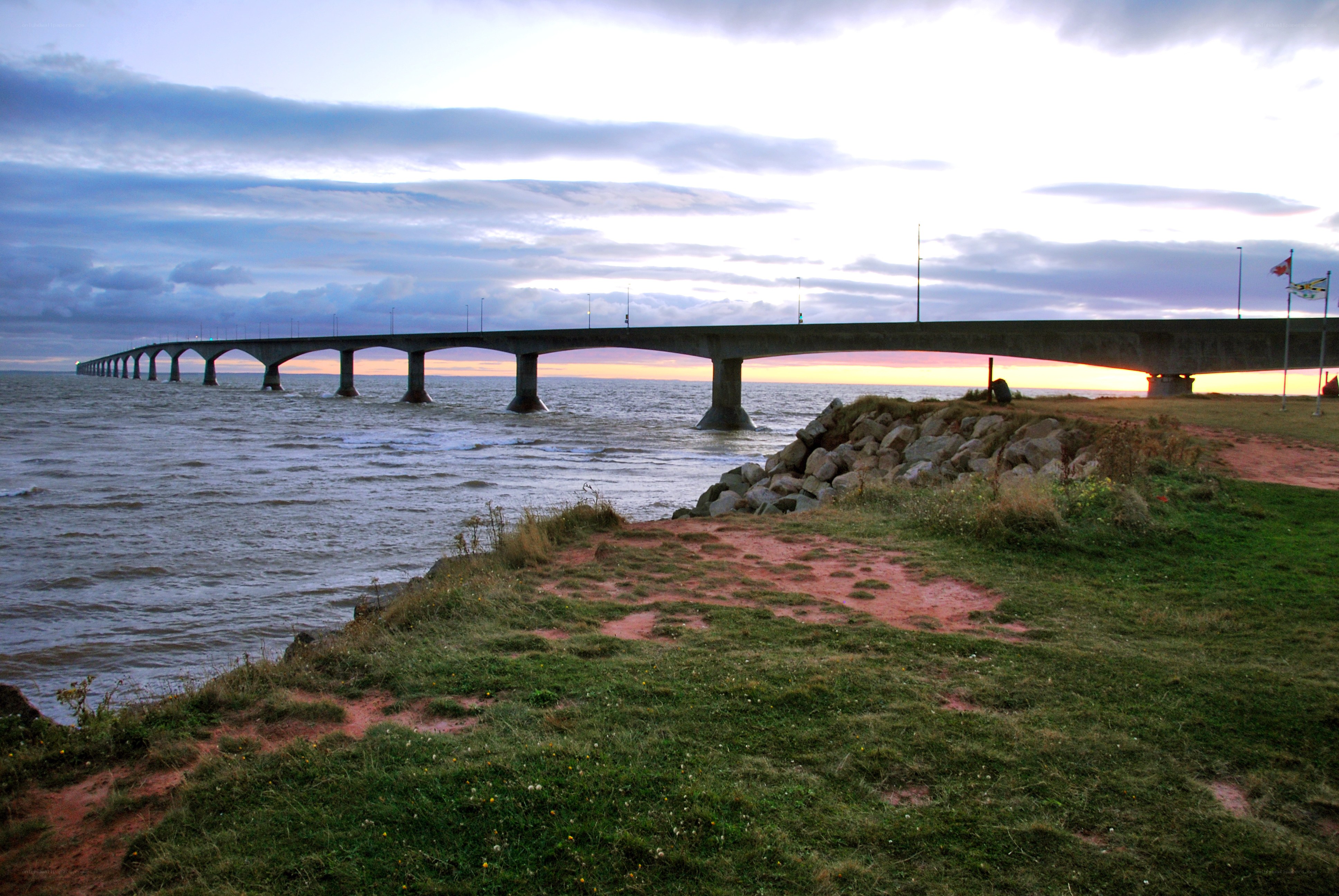 Bridge over water at sunset
