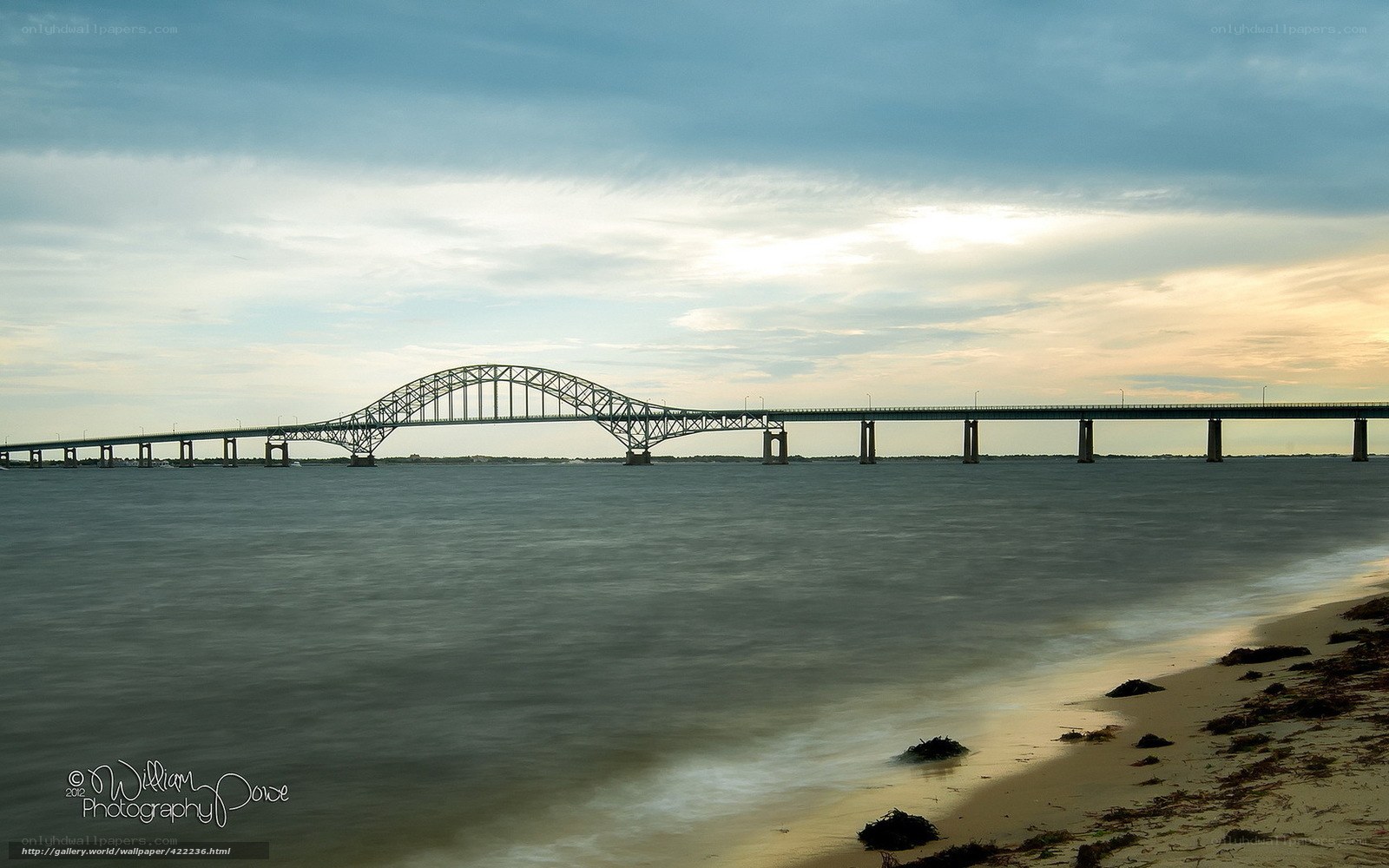 Bridge over water at sunset
