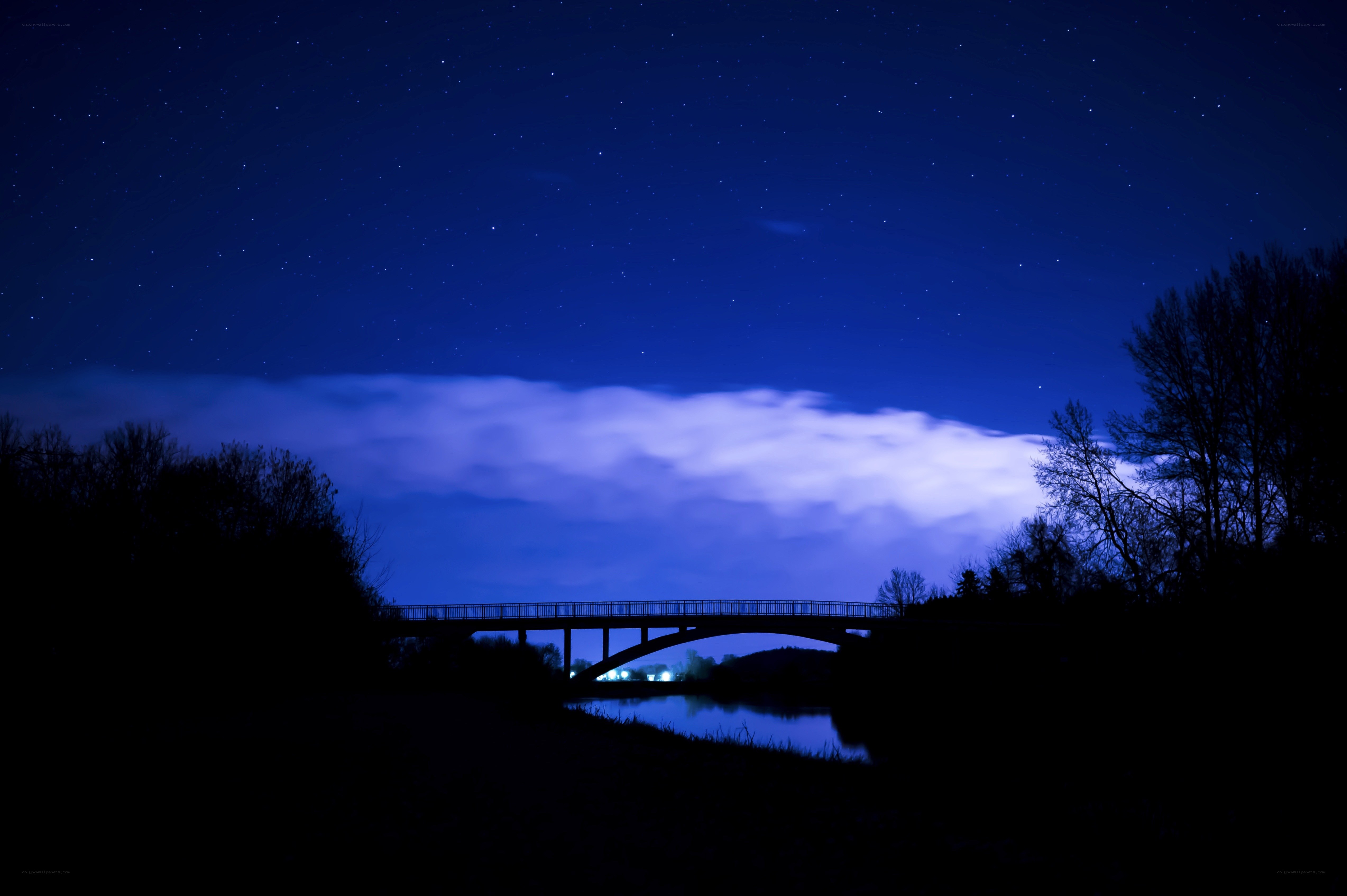 Bridge under starry night sky