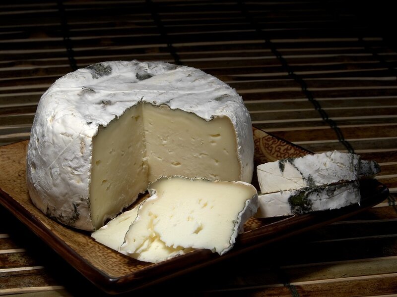 Brie cheese on a wooden plate