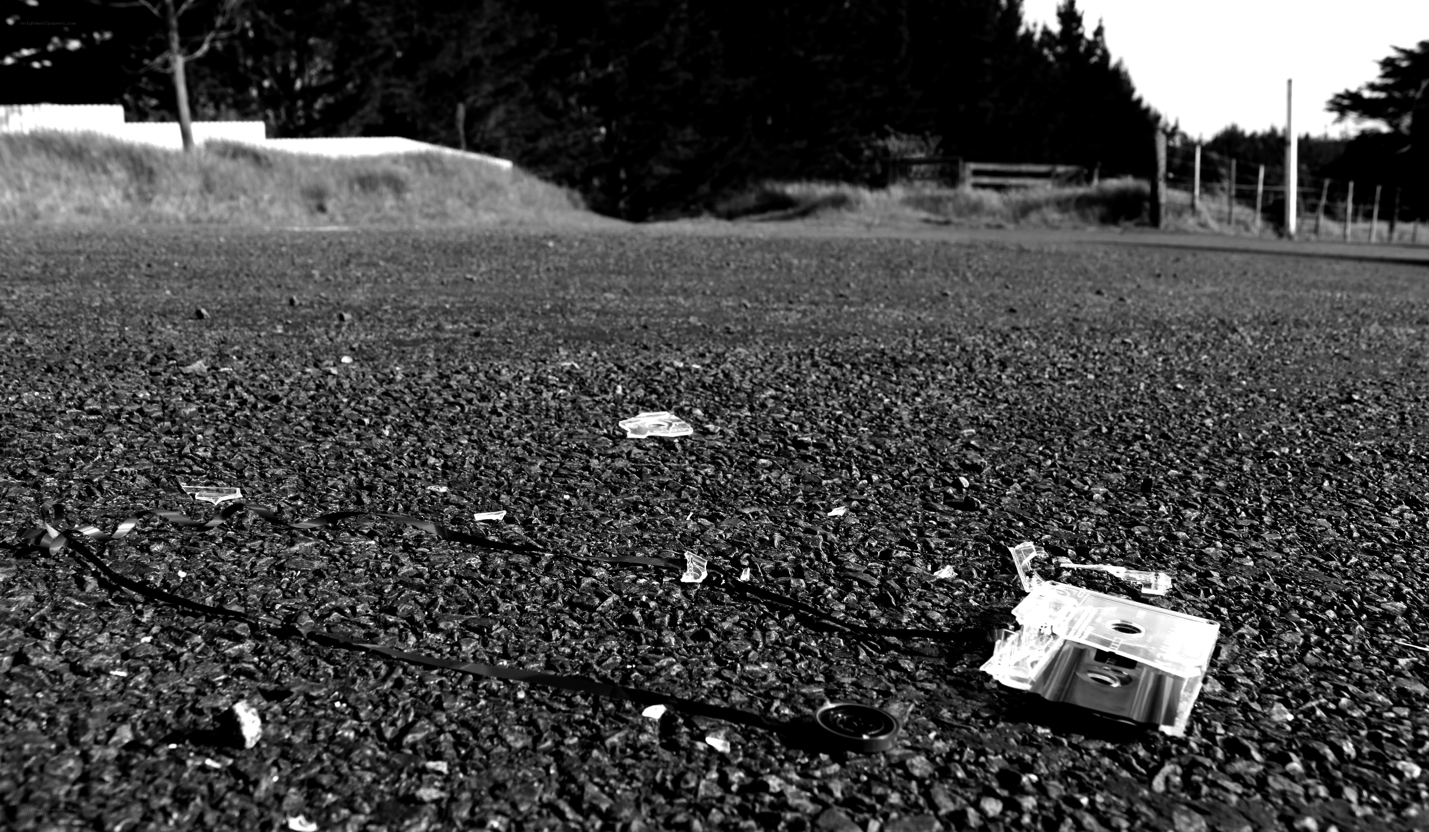 Broken cassette on asphalt