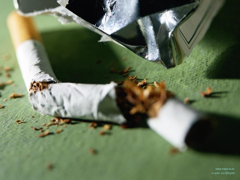 broken cigarette on green surface