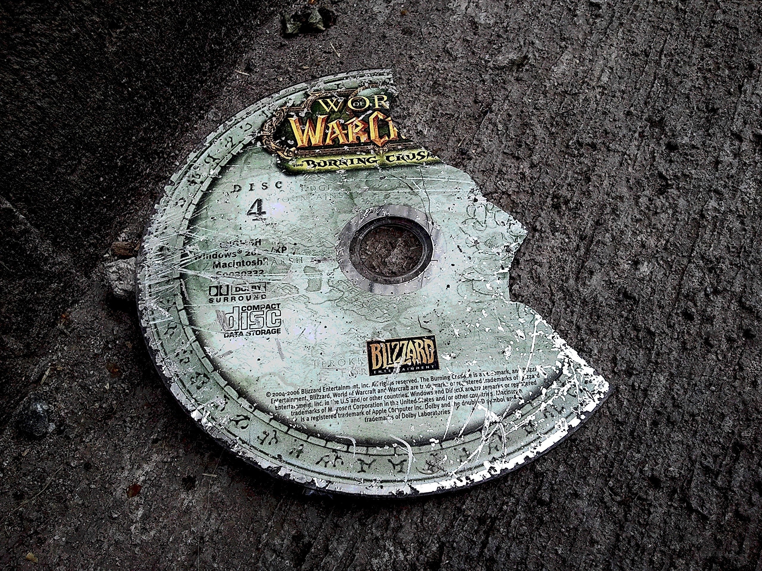 Broken game disc on ground