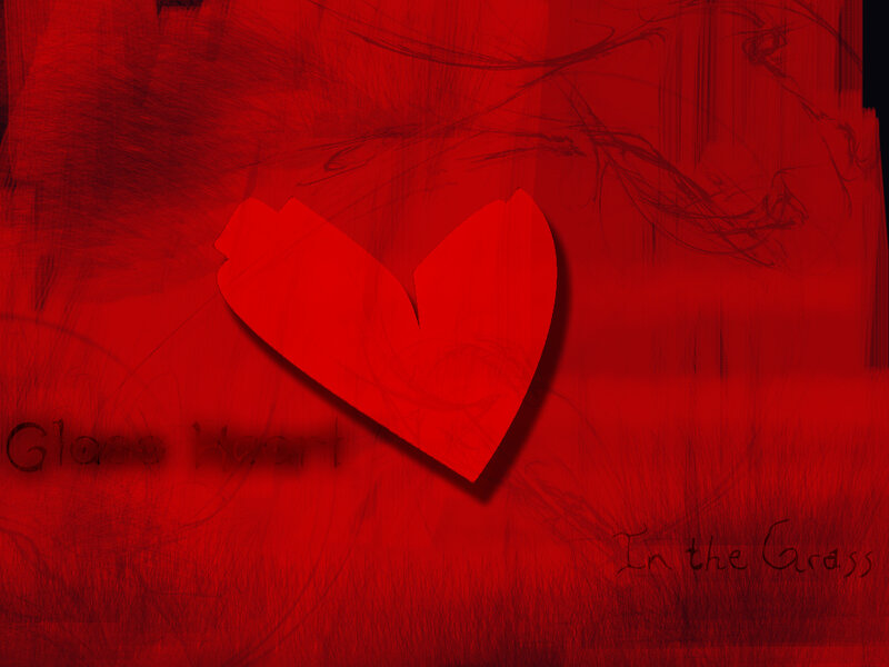 Broken glass heart in grass