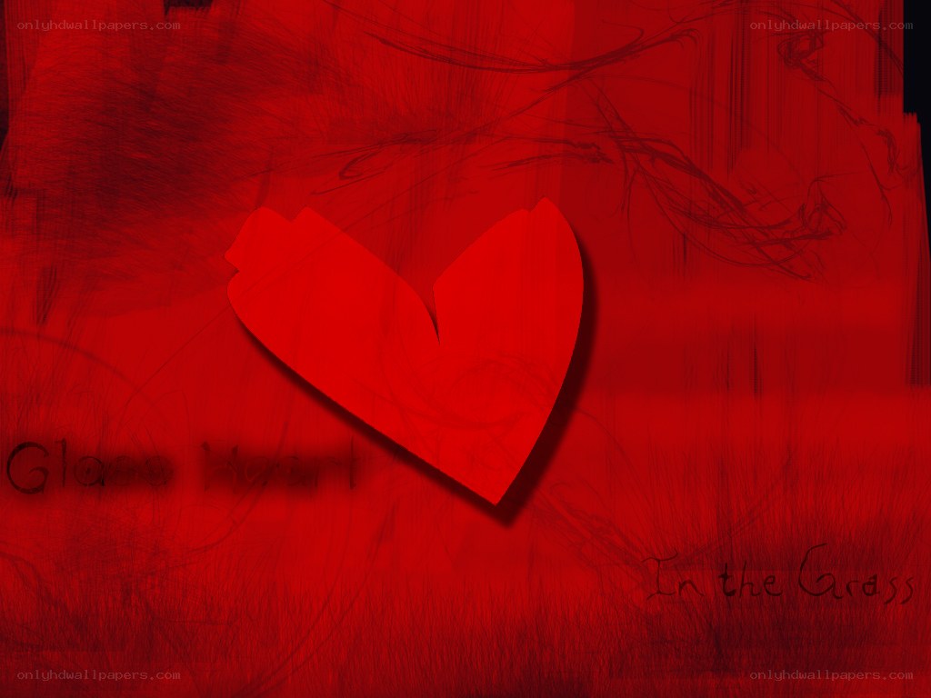 Broken glass heart in grass