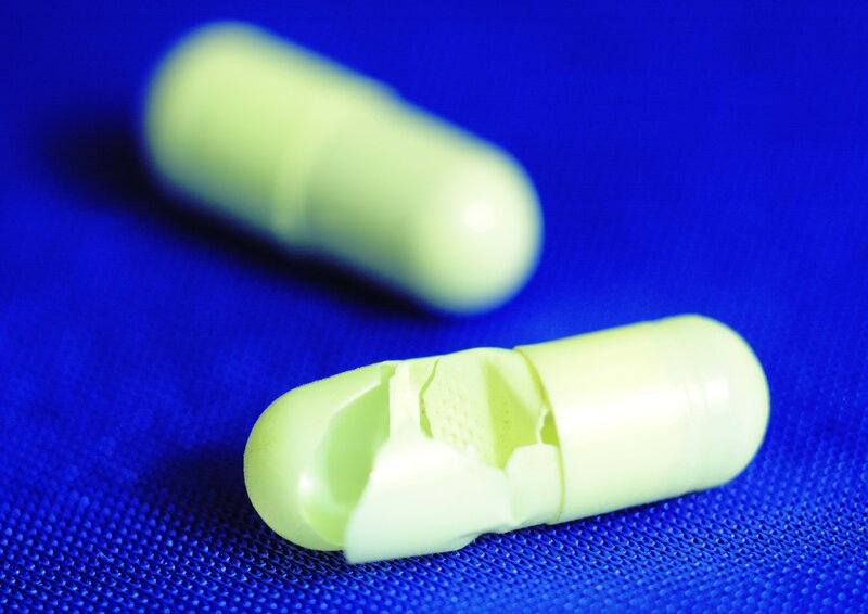 broken green capsule pill