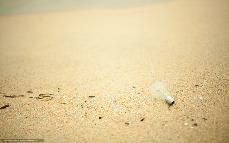 Broken light bulb on beach