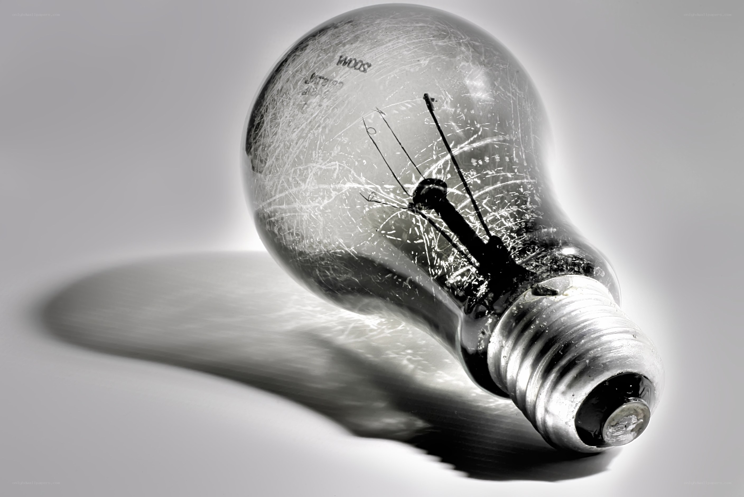 Broken light bulb on white