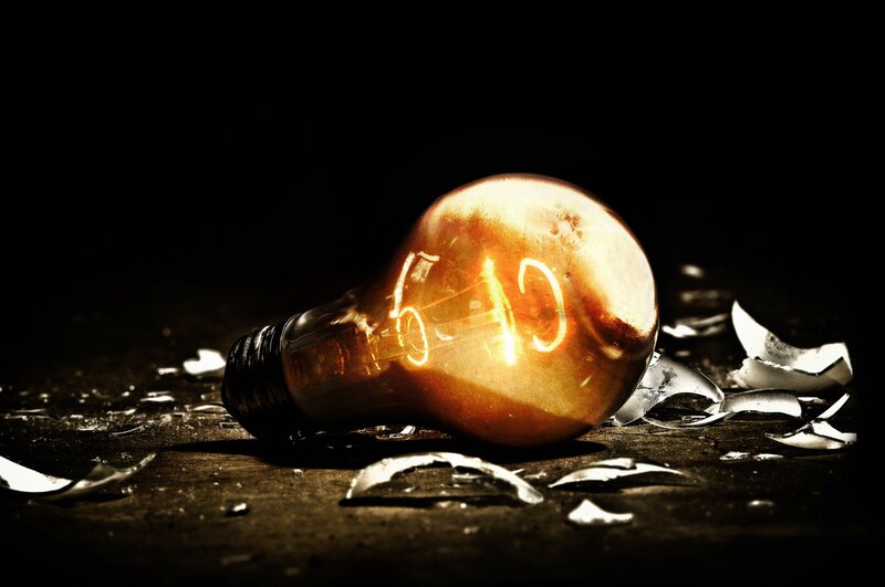 Broken light bulb with glowing filament
