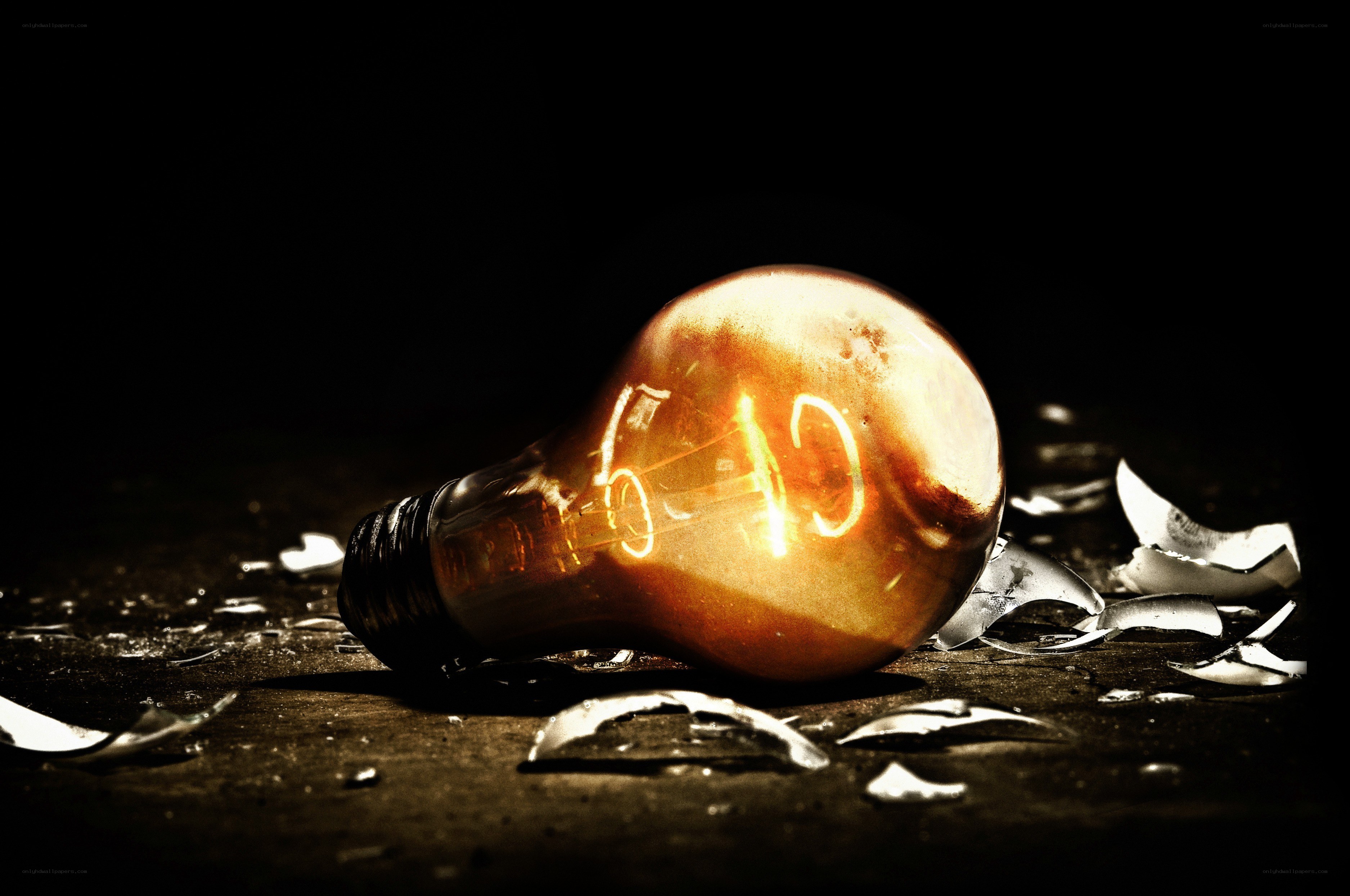 Broken light bulb with glowing filament