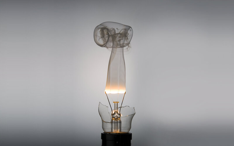 Broken light bulb with smoke