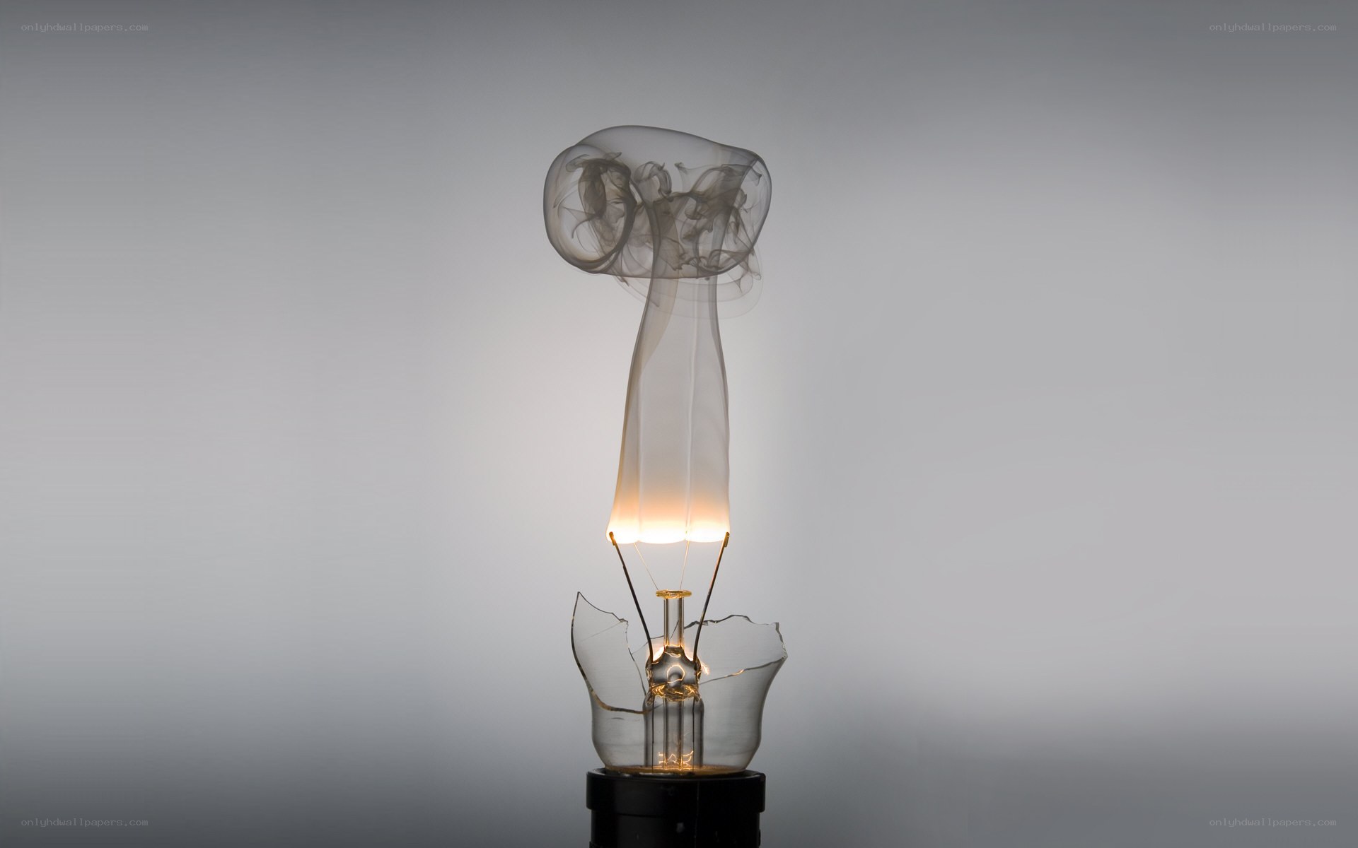 Broken light bulb with smoke