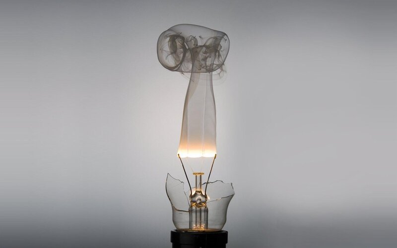 Broken light bulb with smoke