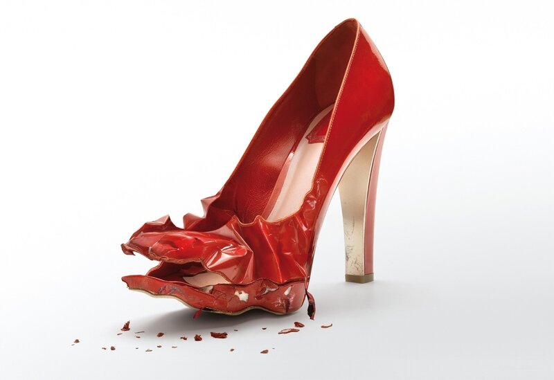 Broken red high-heeled shoe