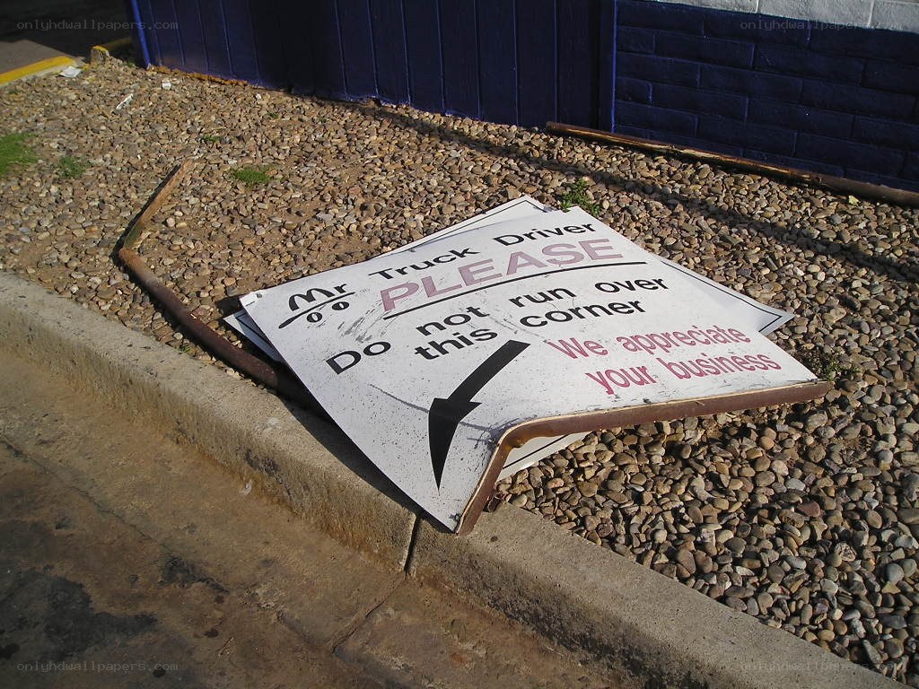 Broken sign on gravel