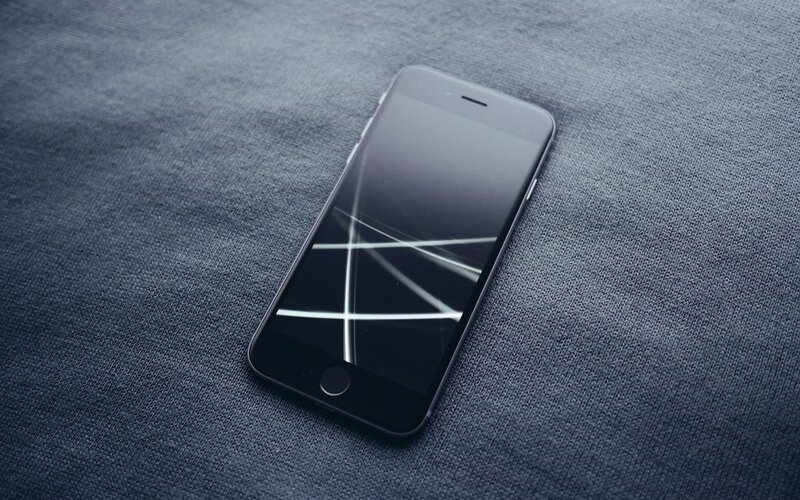 broken smartphone on fabric