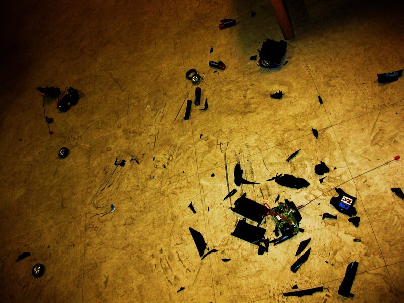 Broken toy car parts on floor