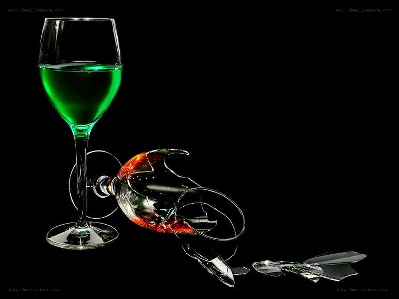 Broken wine glass with green liquid