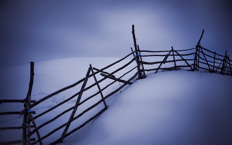 Broken Wooden Fence in Snow