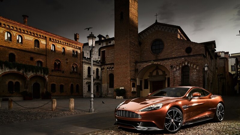 Bronze Sports Car — Brown, Dramatic, Night, Photograph, Brick Buildings, Church, Cobblestone Street, Street Lamp
