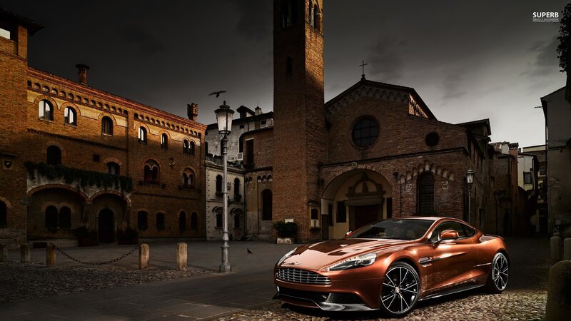 Bronze Sports Car — Brown, Dramatic, Night, Photograph, Brick Buildings, Church Tower, Cobblestone Street