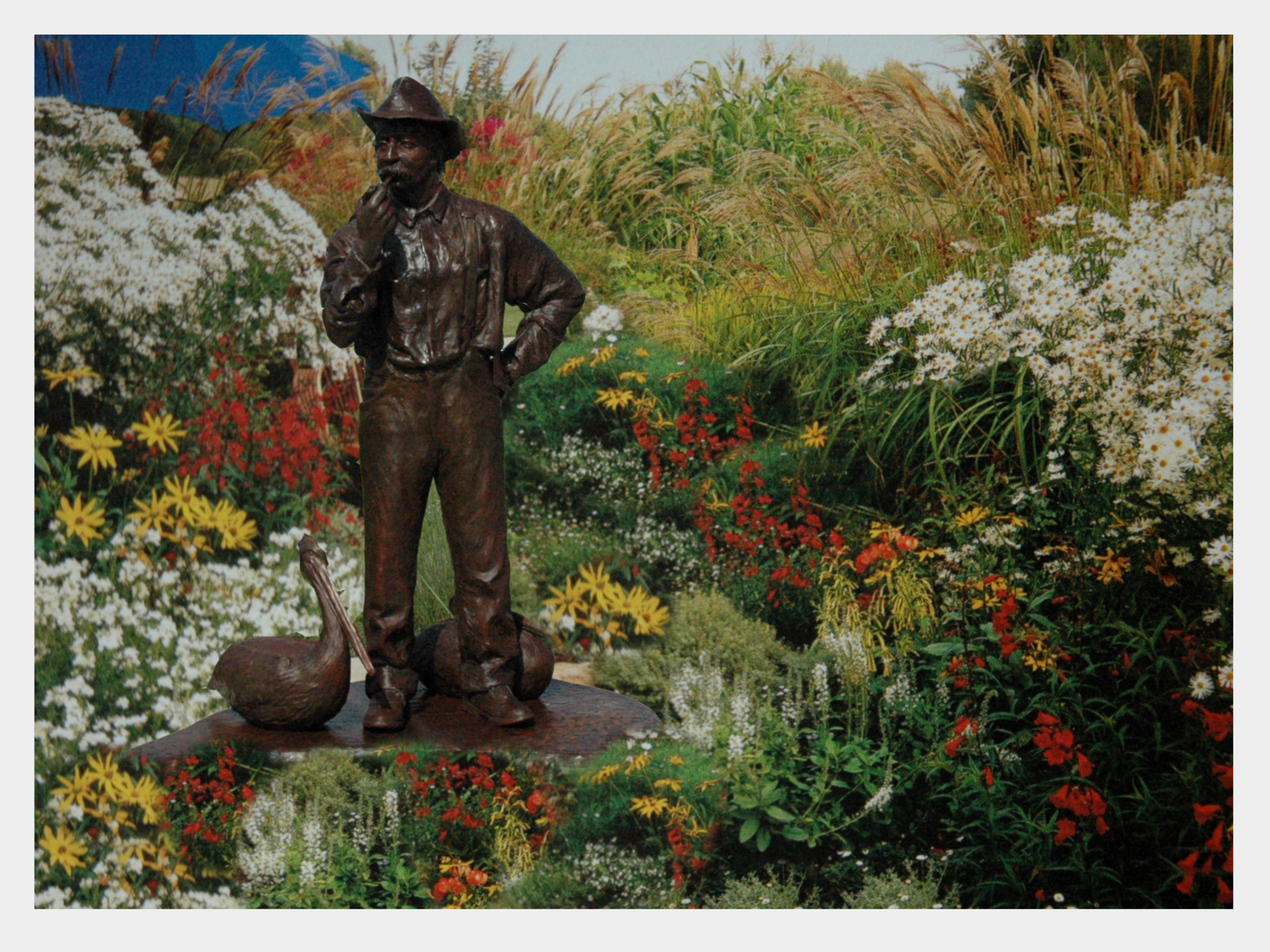 Bronze statue in flower garden