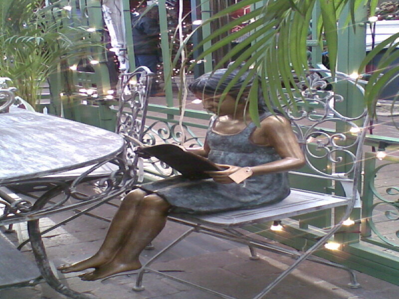 Bronze statue of girl reading