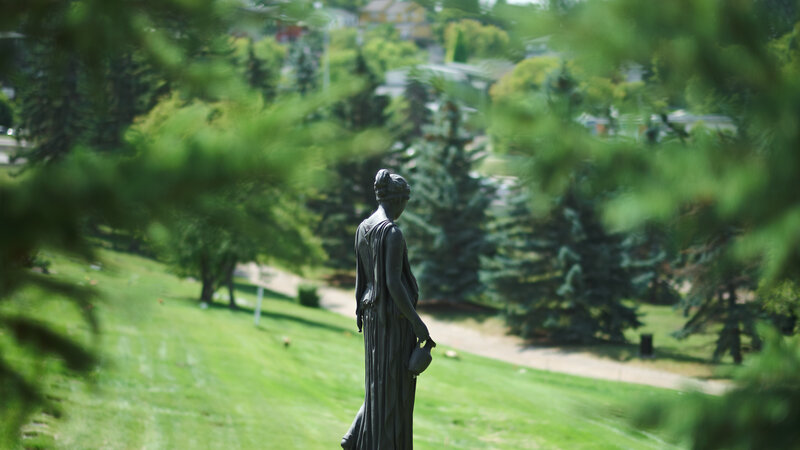 Bronze Statue of Woman — Green, Serene, Afternoon