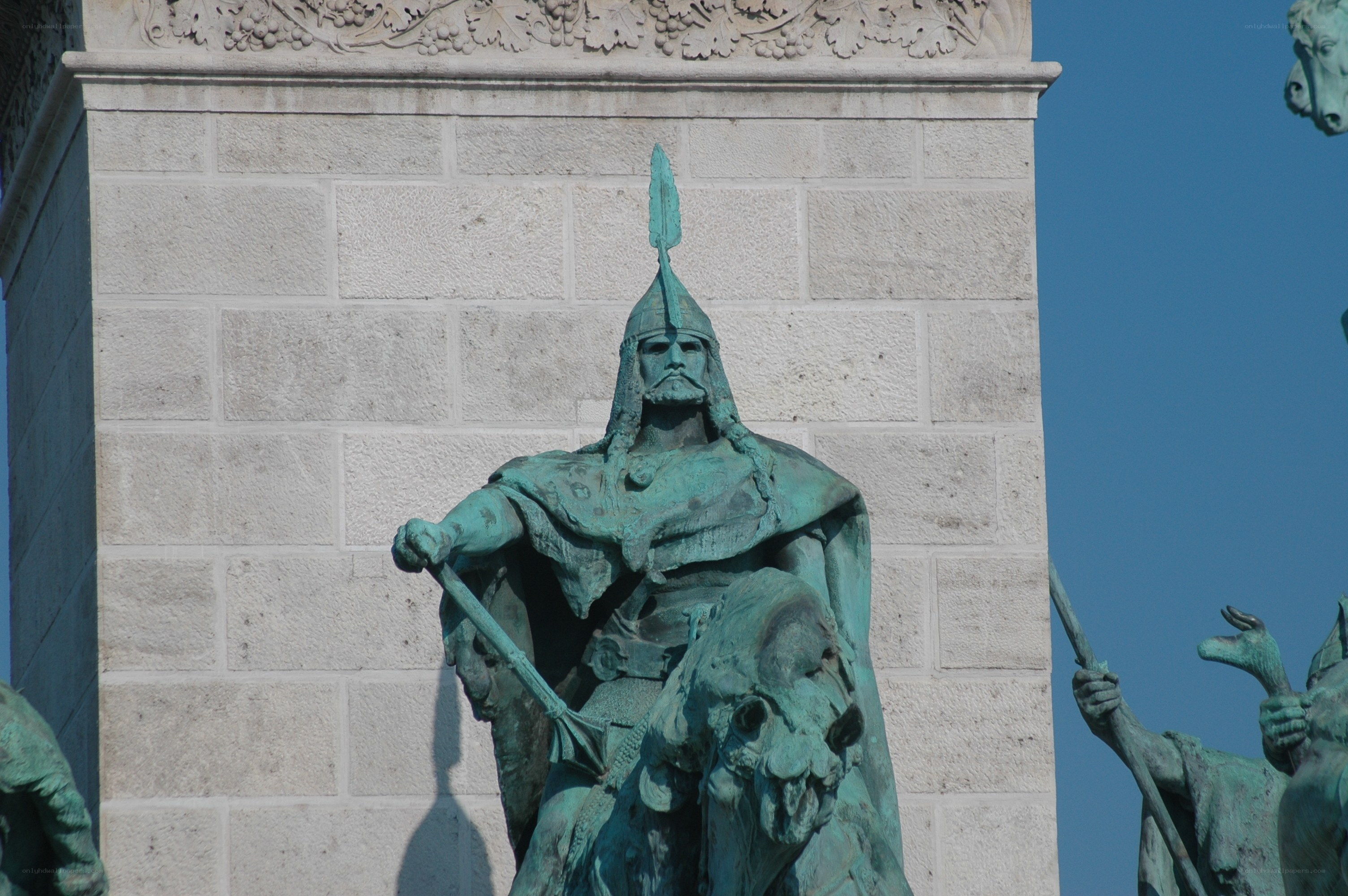 bronze statue on stone pillar