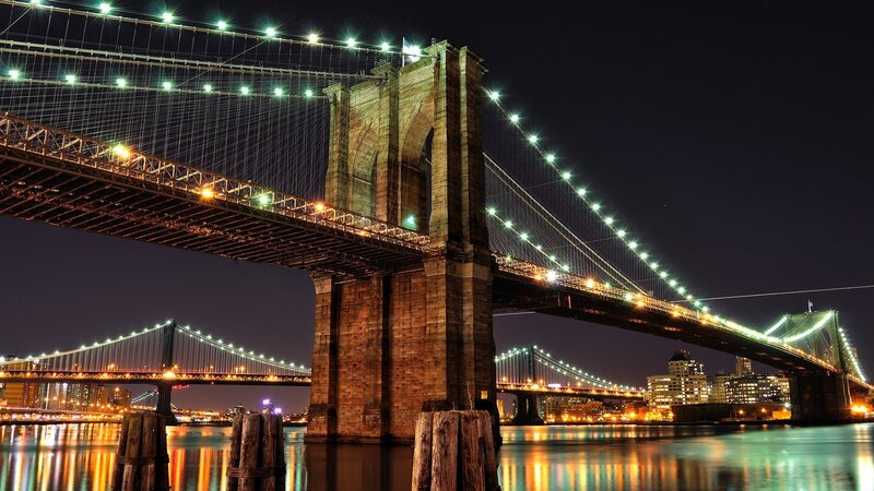 Brooklyn Bridge at Night — Black, Dramatic, Photograph, City Skyline, River, Lights, Pilings