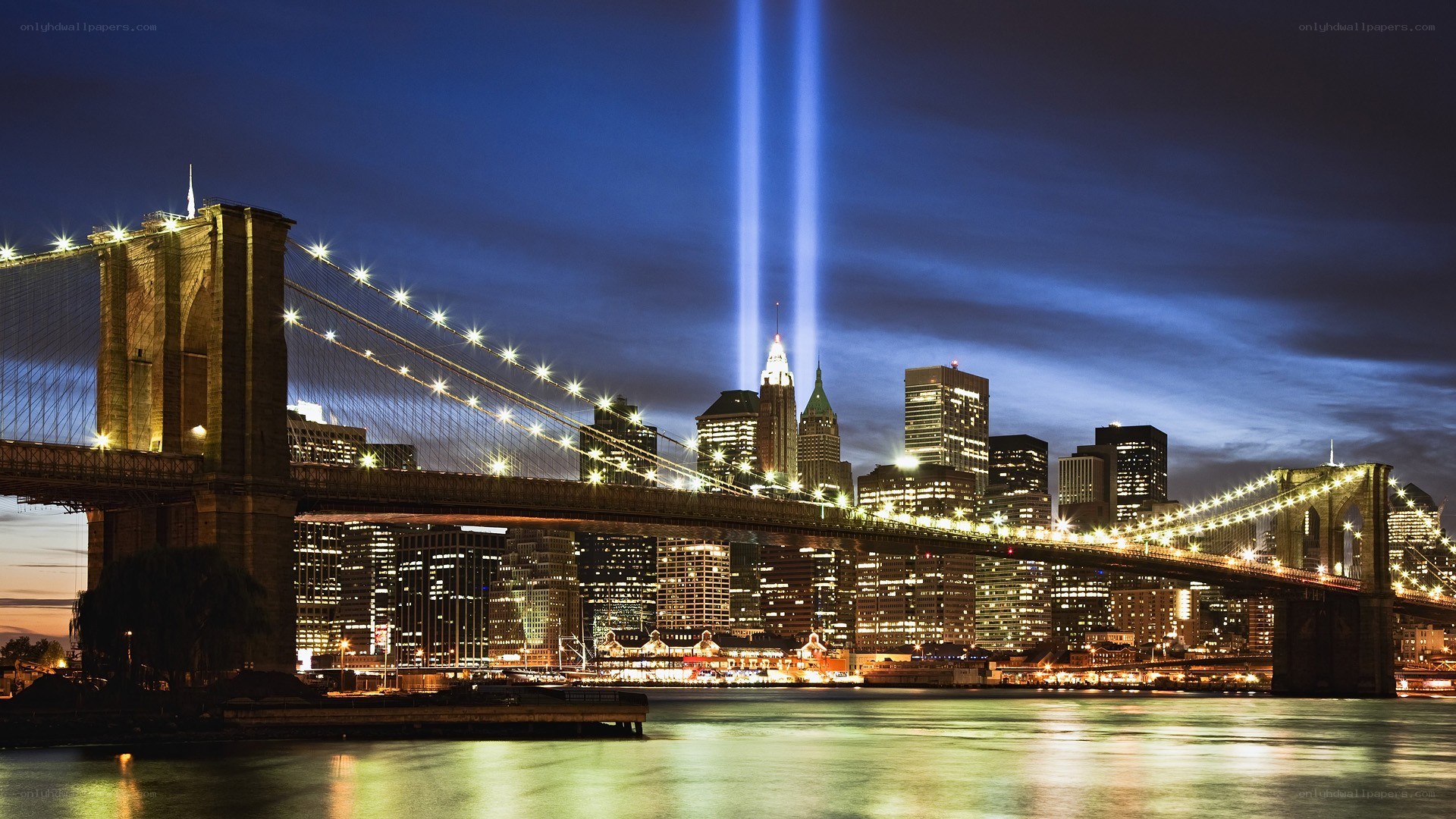 Brooklyn Bridge at night with light beams
