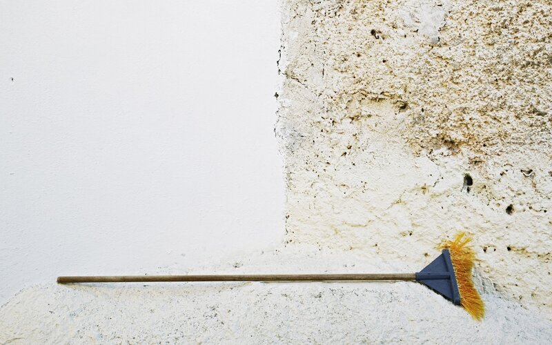broom leaning against wall
