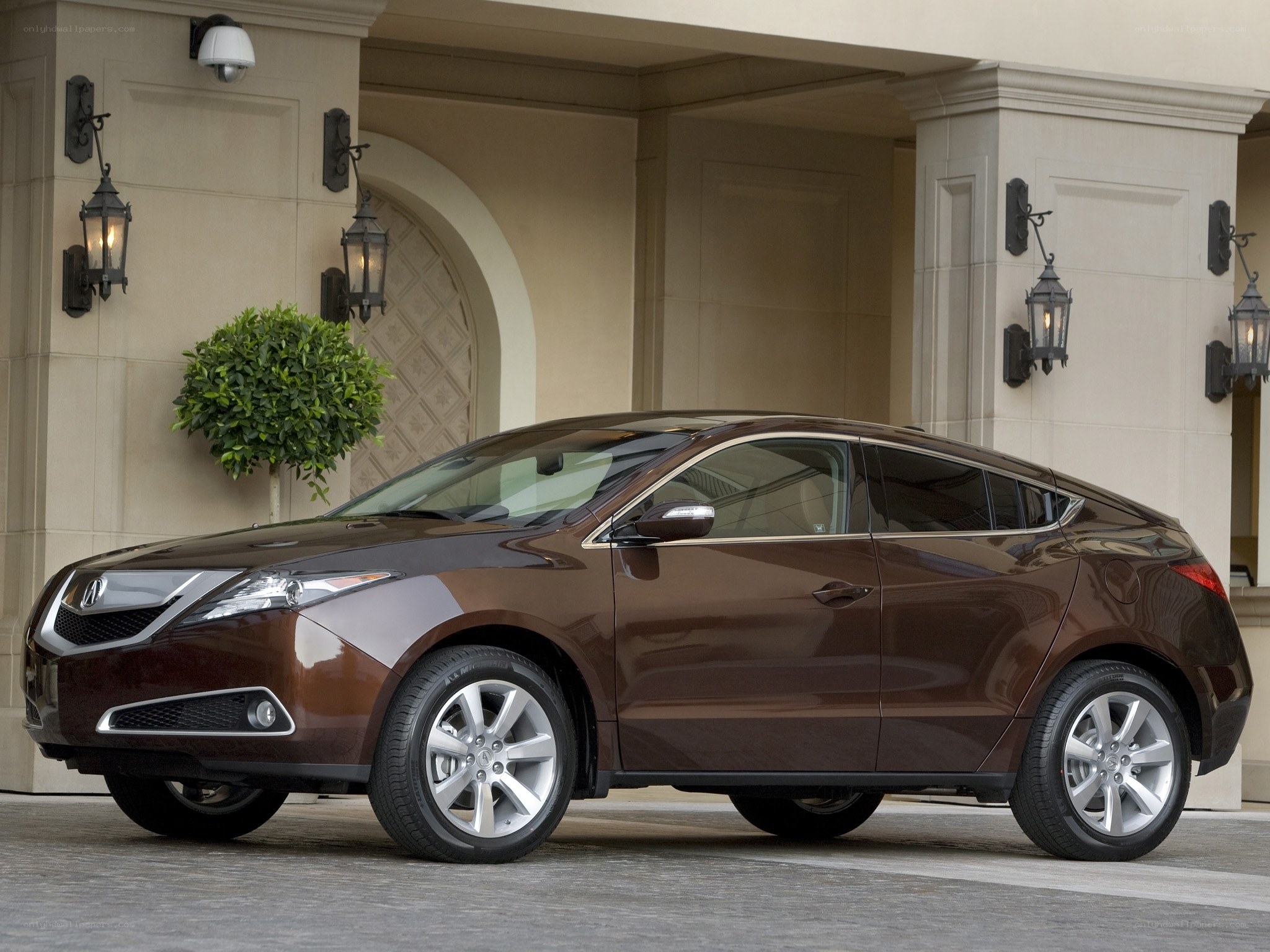 Brown Acura ZDX parked outside