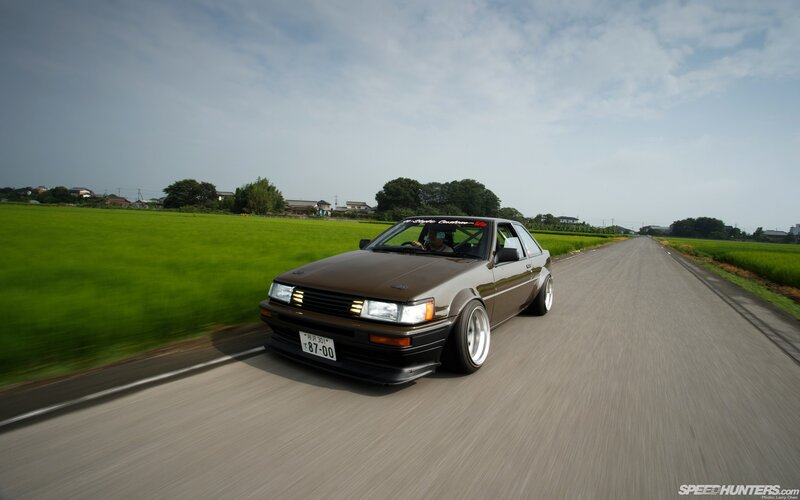 brown ae86 on rural road