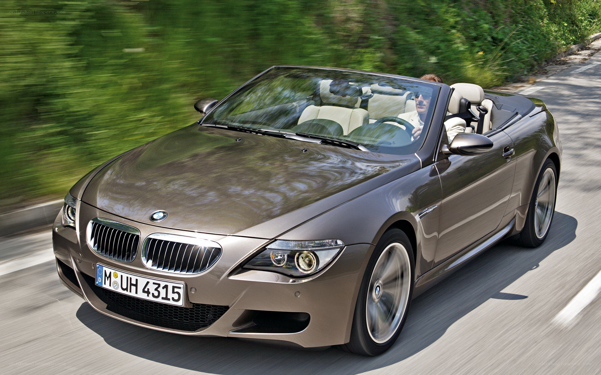 Brown BMW convertible on road