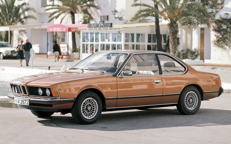 Brown BMW coupe on a sunny street